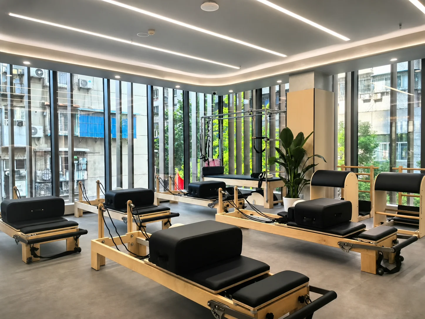 Unbranded commercial Pilates studio with reformers and tower systems
